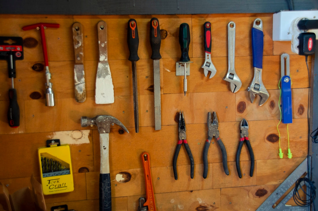 a bunch of tools are hanging on a wall