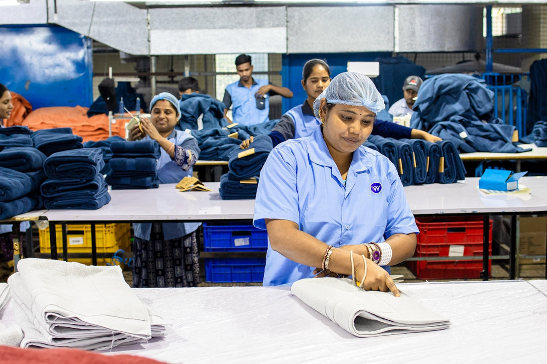 Workers are busy folding and inspecting textiles.