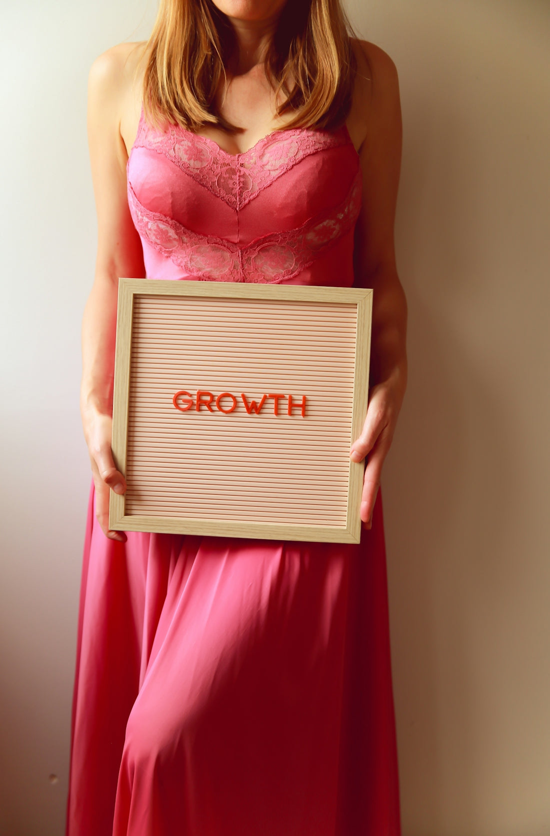 Woman holds a sign that says growth.